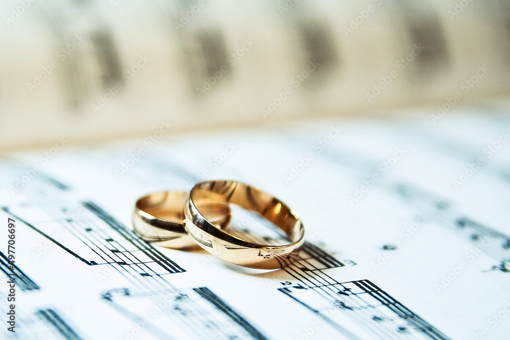 wedding rings is on musical notes close-up wedding rings is on musical notes close-up