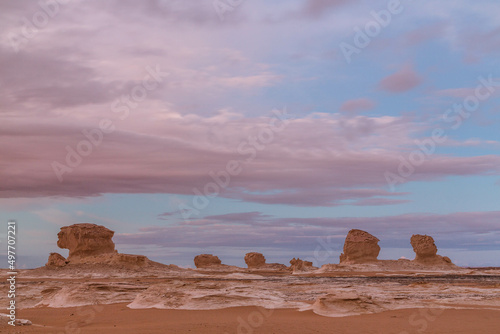 Wind eroded rock formations and pink clouds. Western Desert, Egypt