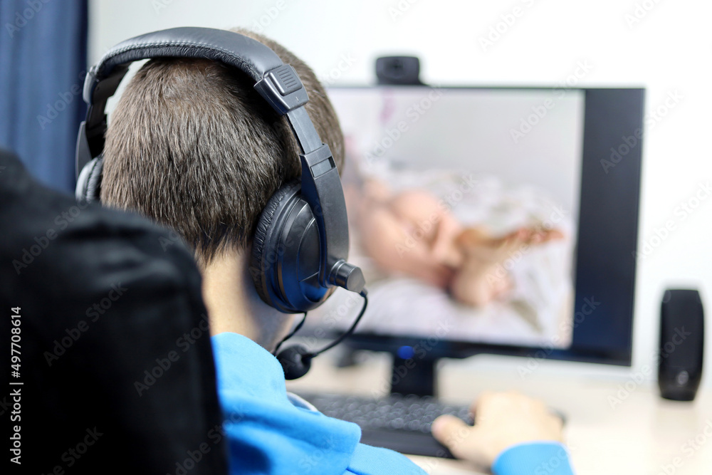 Man in headset watching adult photo or video on PC display sitting in office chair. Concept of webcam model, porn movies Man in headset watching adult photo or video on PC display sitting in office chair. Concept of webcam model, porn movies