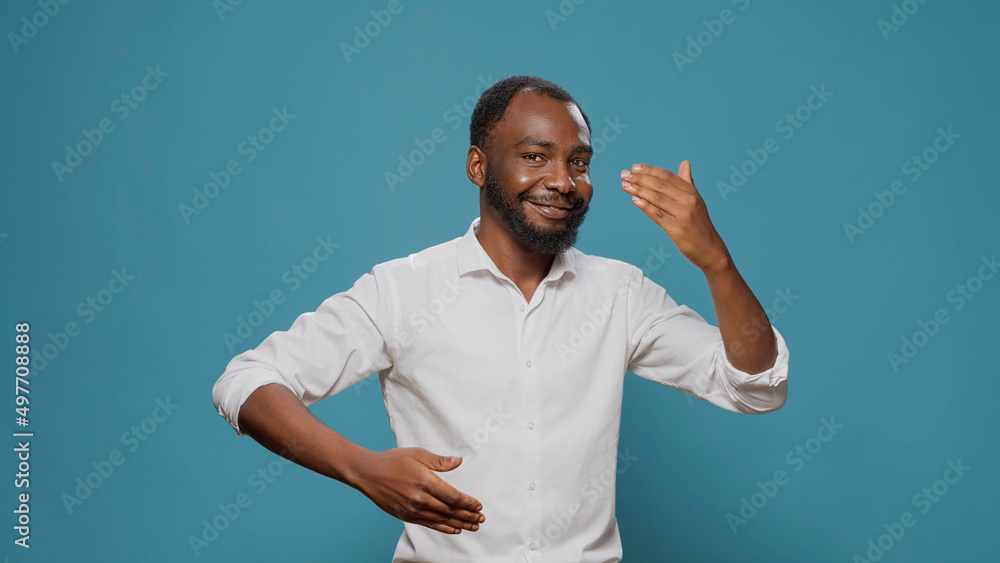 African american man showing robot dance moves in studio, doing unique party dancing and movement on contemporary urban music. Male performer moving on disco sound with robotic action. African american man showing robot dance moves in studio, doing unique party dancing and movement on contemporary urban music. Male performer moving on disco sound with robotic action.