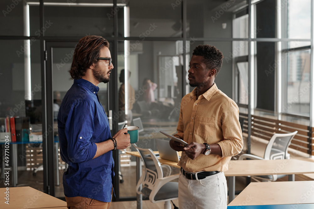 custom made wallpaper toronto digitalYoung multi-ethnic managers standing in coworking space and discussing new project while one of them drinking coffee