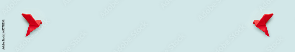 two red paper origami pigeon on pastel blue background two red paper origami pigeon on pastel blue background