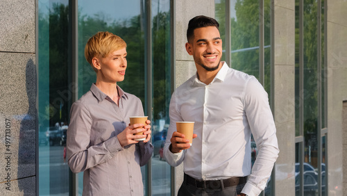 Fotografie Two multi-ethnic business partners multiracial colleagues arabic spanish man and