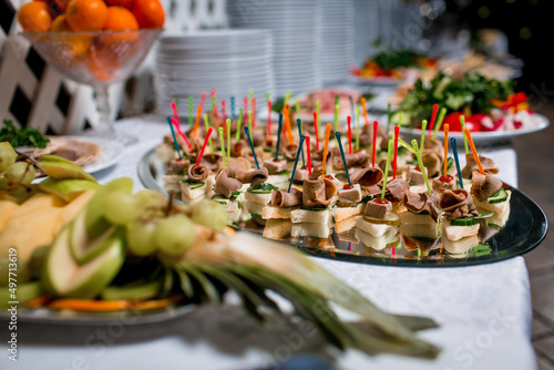 Decorated catering banquet table with different food appetizers assortment on a party photo