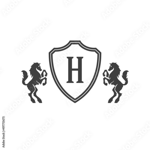 Heraldic horses and monogram on shield isolated on white background vector icon in retro style. Can be used for crest logo or heraldic badge.