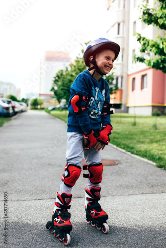Smiling boy roller skating. Portrait of a boy on roller skates