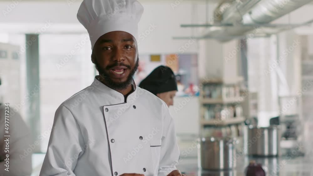 POV of african american chef filming cooking show with camera, learning gastronomy dish preparations on online class. Authentic cook broadcasting culinary content in ktichen. Handheld shot. POV of african american chef filming cooking show with camera, learning gastronomy dish preparations on online class. Authentic cook broadcasting culinary content in ktichen. Handheld shot.