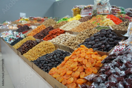 Almaty, Kazakhstan - 12.23.2021 : Various dried fruits in containers on an open counter in a hypermarket