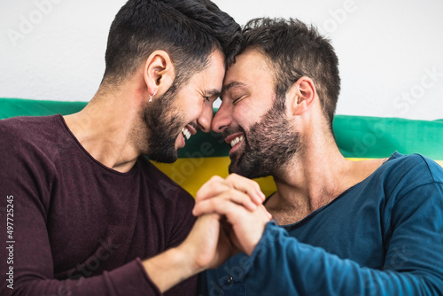 Happy gay couple having romantic moments in bed - Homosexual love relationship and gender equality concept