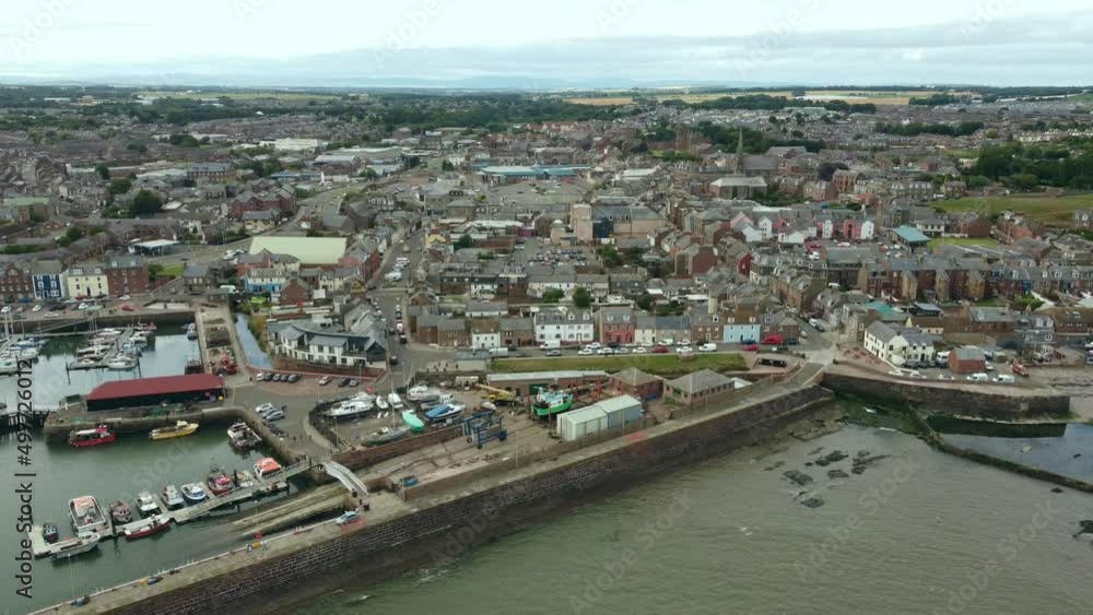 A drone view of the sea pier and the old streets of a Scottish town. A drone view of the sea pier and the old streets of a Scottish town.