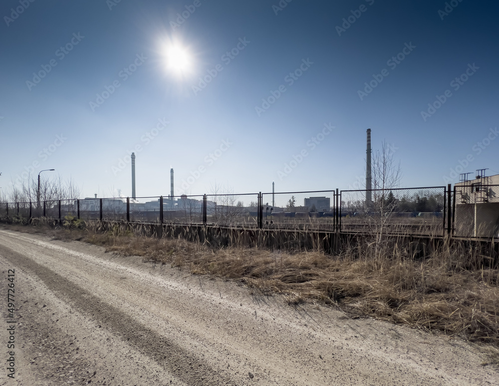 The sun over the high, emission-generating chimneys of the zinc and lead smelter in Miasteczko Slaskie.
