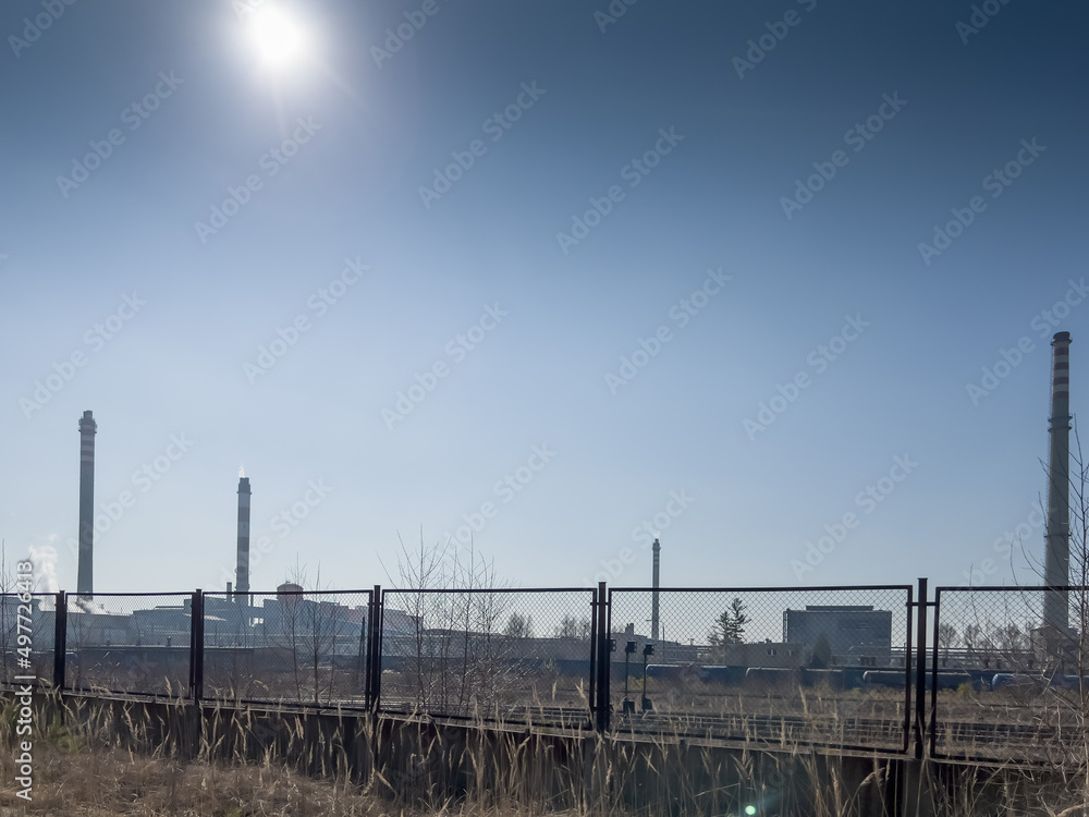 The sun over the high, emission-generating chimneys of the zinc and lead smelter in Miasteczko Slaskie. The sun over the high, emission-generating chimneys of the zinc and lead smelter in Miasteczko Slaskie.