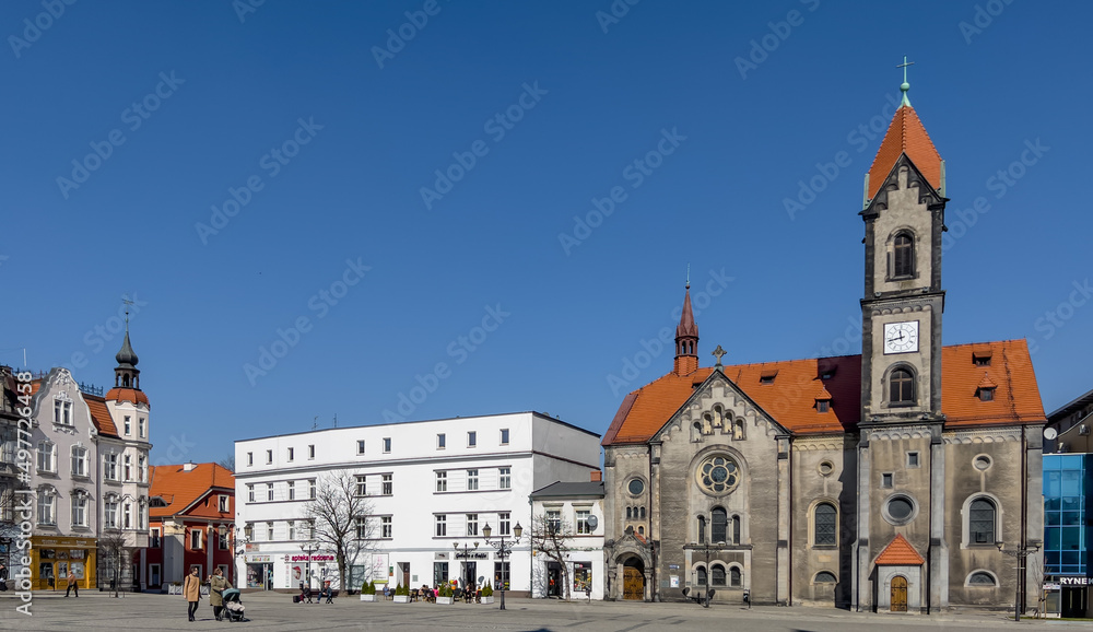 Fototapeta premium Tarnowskie Gory, Poland, March 22, 2022: The town square with a visible Evangelical-Augsburg Savior Church in Tarnowskie Góry and old houses.