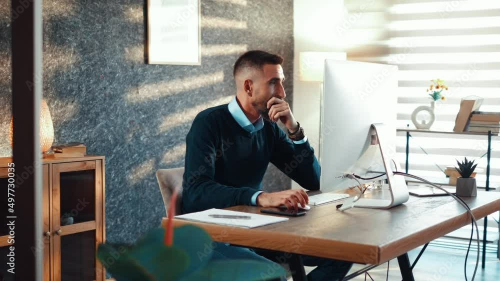 Young businessman analyzing financial statistics on a computer monitor, looking forward to a successful business. Young businessman analyzing financial statistics on a computer monitor, looking forward to a successful business.