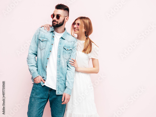 Sexy smiling beautiful woman and her handsome boyfriend. Happy cheerful family having tender moments near wall in studio.Pure cheerful models hugging.Embracing each other. Cheerful and happy