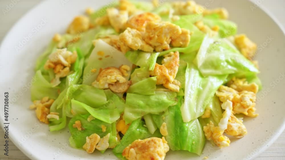 homemade stir-fried cabbage with egg on plate homemade stir-fried cabbage with egg on plate