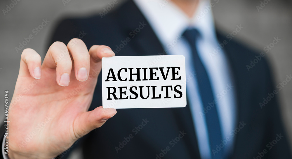 Businessman presenting 'Achieve results' word on white card Businessman presenting 'Achieve results' word on white card