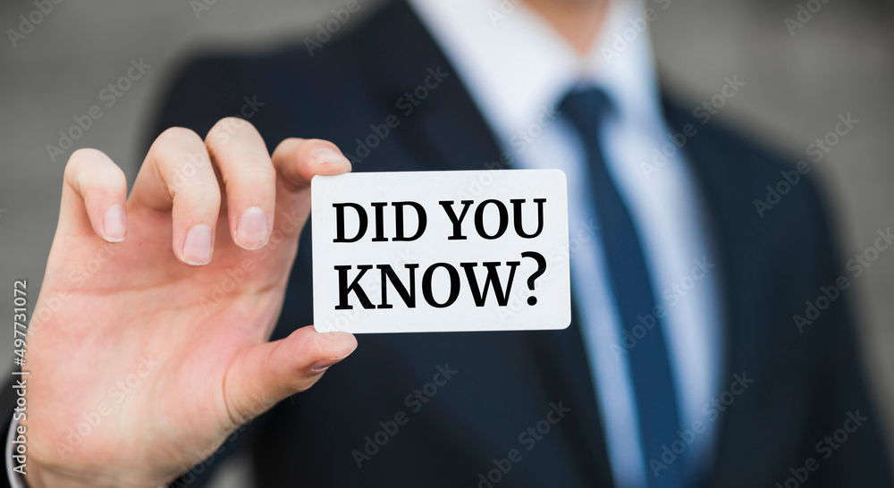 Businessman presenting 'Did you know?' word on white card Businessman presenting 'Did you know?' word on white card