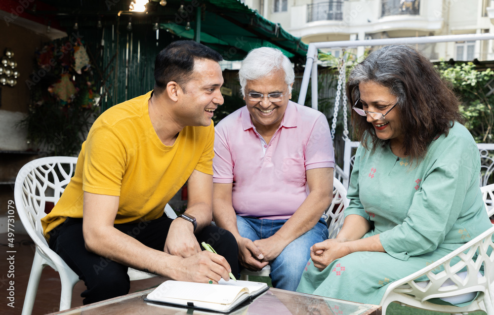senior Man woman having conversation with financial advisor at home senior Man woman having conversation with financial advisor at home