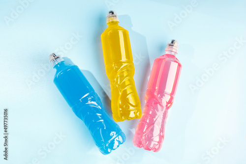 Plastic bottles with colored liquid. Colored bottles of sports nutrition, isotonics.