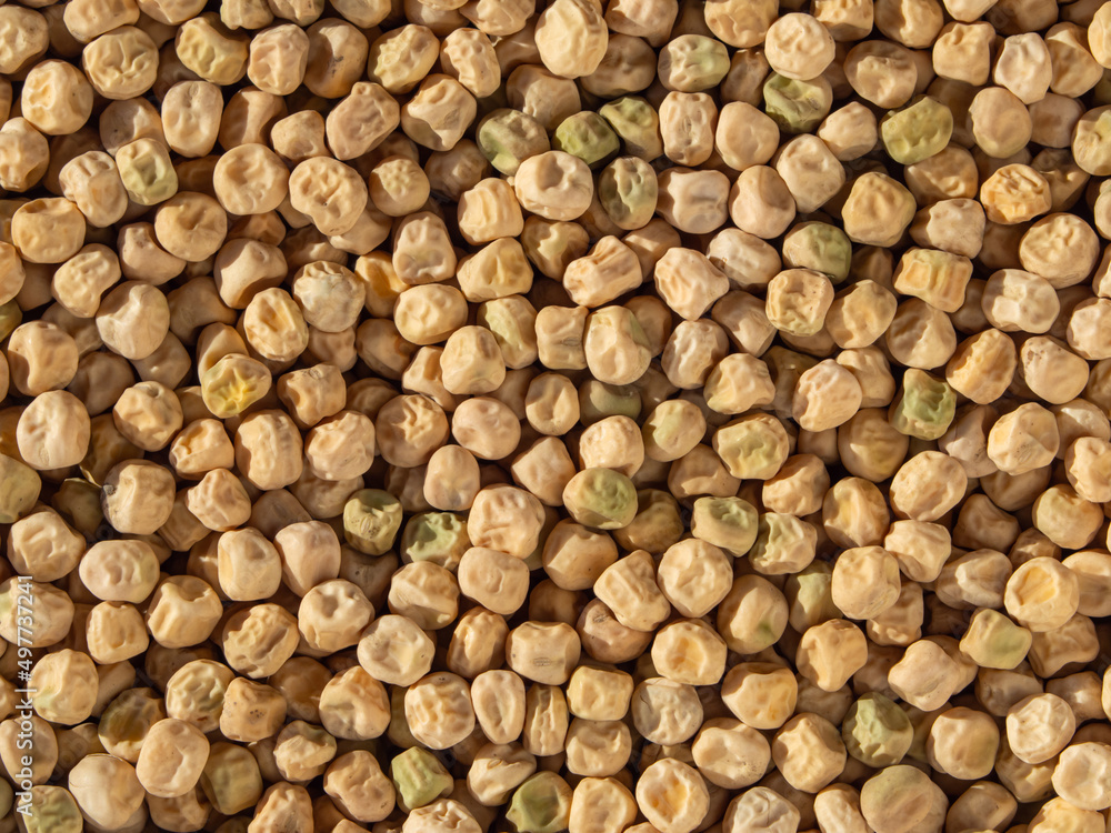Food-grade natural textured background of yellow dried pea seeds. Pea background. Close-up of whole organic dry peas Top View Food-grade natural textured background of yellow dried pea seeds. Pea background. Close-up of whole organic dry peas Top View