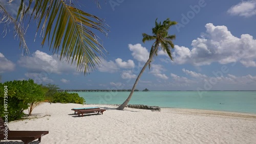 Paradise place in Domenican Republic. Small beautiful wild beach on paradise island Maldives. Beach chairs on blue sea on white sand. Boats on horizon Dominican Republic Punta Cana. Isolated Tropical photo