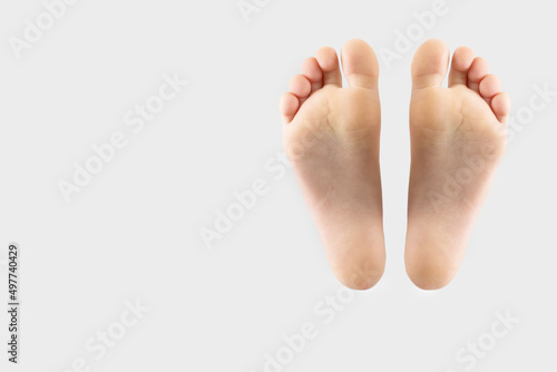 two feet isolated on gray background with copy space. © Tania