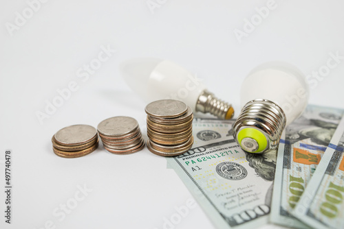 dollars cents and two energy saving light bulbs.