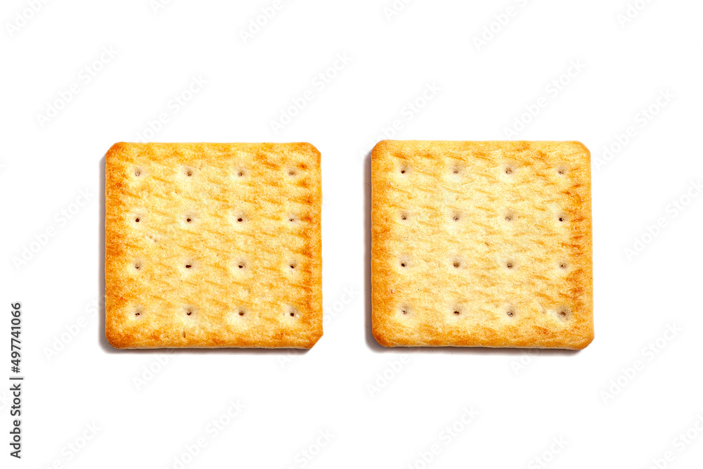 Salty cracker cookies on a white background. A couple of biscuit on the table. Morning breakfast snack. Wheat light meal snack in lunch time. Salty cracker cookies on a white background. A couple of biscuit on the table. Morning breakfast snack. Wheat light meal snack in lunch time.