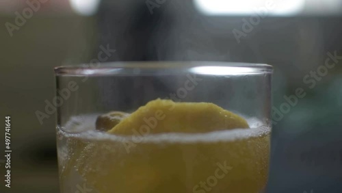 Healthy vitamins in the glass full of hot water lemon slices and honey - soar throat remedy photo