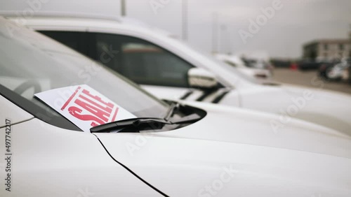 Close up of sale banner from new car. Concept of purchase and selling car. Auto business concept. Car dealerships, used cars,luxury cars,auto dial.