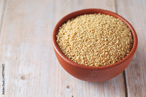 Dry couscous in a small ceramic bowl 