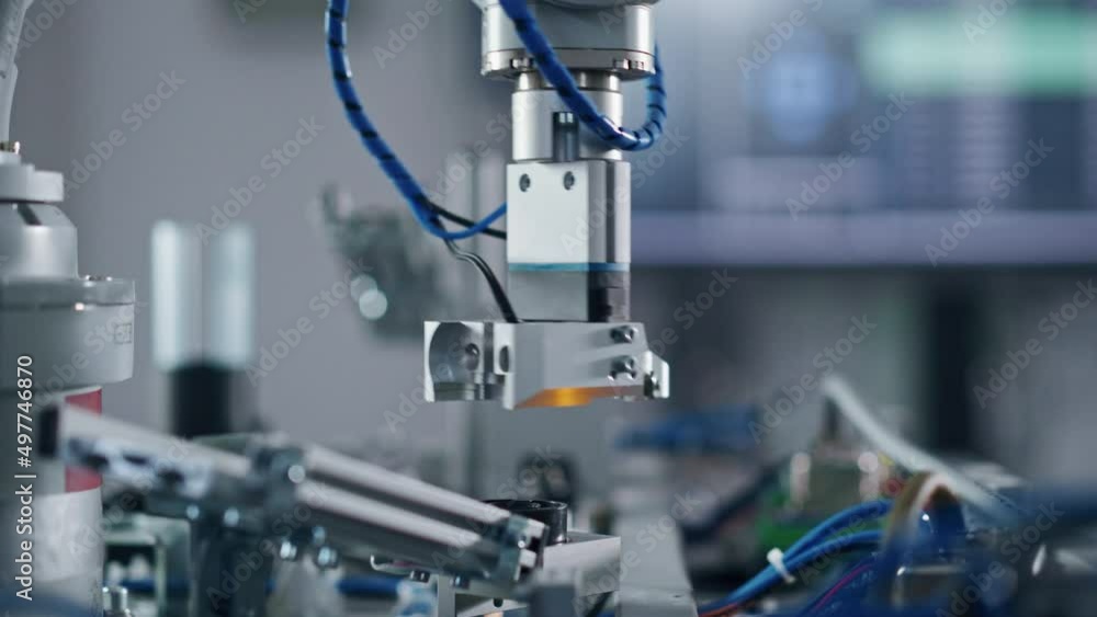 Robotics Industry Four Engineering Facility Robot Arm Moving at Different Directions. High Tech Industrial Technology Using Modern Machine Learning. Mass Production Automatics. Close Up Robotics Industry Four Engineering Facility Robot Arm Moving at Different Directions. High Tech Industrial Technology Using Modern Machine Learning. Mass Production Automatics. Close Up