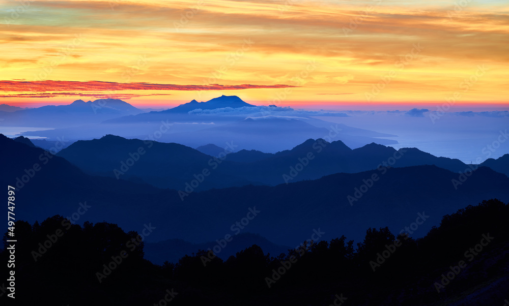 Sunrise over the mountains
 at Kelimutu volcano. Ende Regency, East Nusa Tenggara, Flores, Indonesia, Asia. Travel photo.