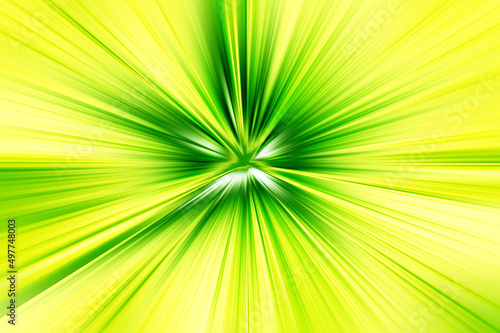 Abstract radial zoom blur surface in light green and light yellow tones. Bright Glow green-yellow background with radial, radiating, converging lines. 