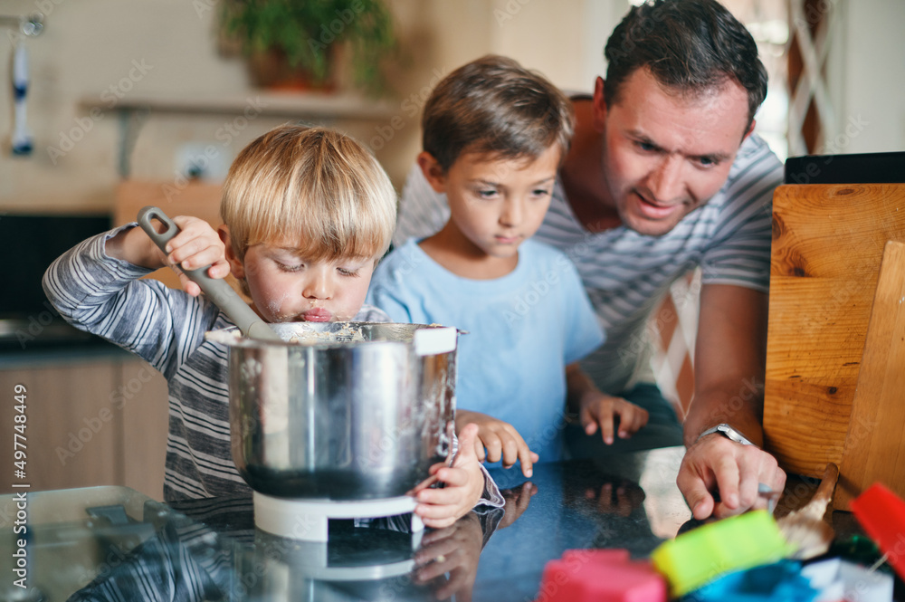 Not just baking, its a time to bond. Shot of a young man baking with his two adorable sons at home. Not just baking, its a time to bond. Shot of a young man baking with his two adorable sons at home.