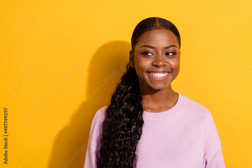 Photo of cheerful adorable lady toothy smile look interested empty space isolated on yellow color background Photo of cheerful adorable lady toothy smile look interested empty space isolated on yellow color background