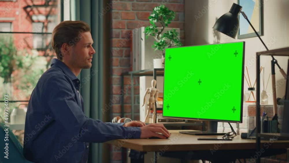 Young Handsome Man Working from Home on Desktop Computer with Green ...