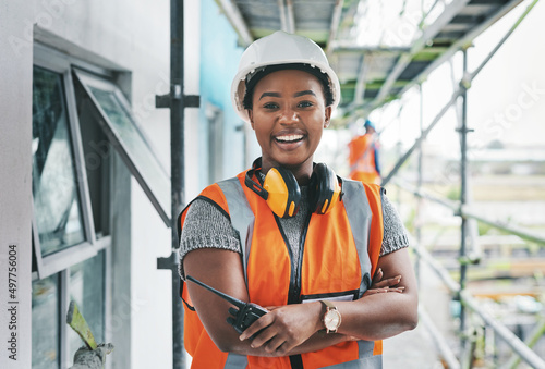 Youll want to invest in this new development. Portrait of a young woman working at a construction site. photo