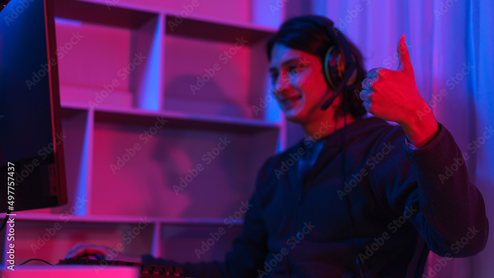 Game stream concept, Male streamer wear headset and have fun to play games online for live stream Game stream concept, Male streamer wear headset and have fun to play games online for live stream