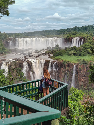 Tourist watching waterfalls at Iguaçu Falls. Iguaçu Falls is a set of about 275 waterfalls on the Iguaçu River.