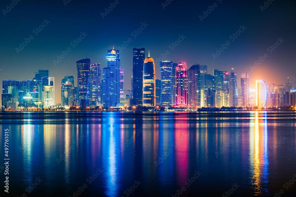 Night view on the centre of the city Doha, Qatar and the Gulf. Many modern luxury building and skyscrapers illuminated with numerous lights.