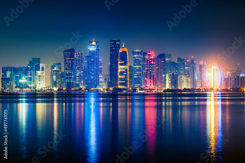 Night view on the centre of the city Doha, Qatar and the Gulf. Many modern luxury building and skyscrapers illuminated with numerous lights. © autau