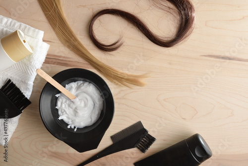 Hair care and coloring products on wooden table top view