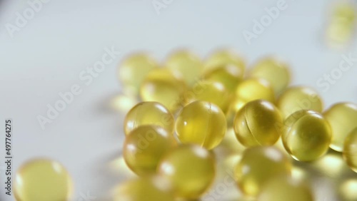 Macro video shot of vitamin d3 capsules on a white background close-up.