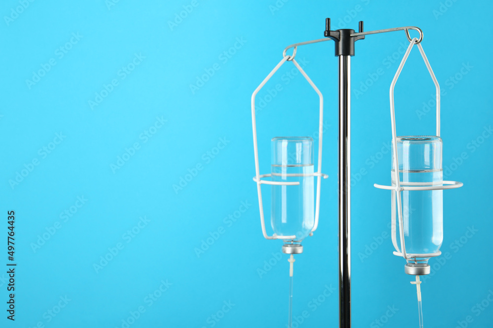 IV infusion set on light blue background. Space for text IV infusion set on light blue background. Space for text
