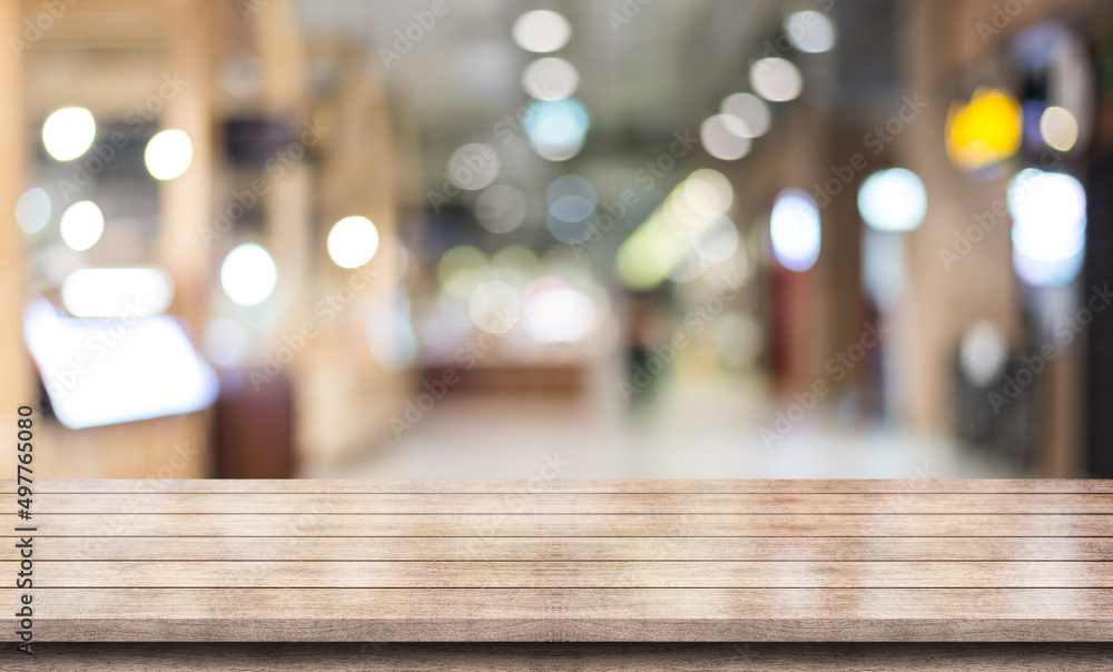 Empty wooden table top with lights bokeh on blur restaurant background. Empty wooden table top with lights bokeh on blur restaurant background.