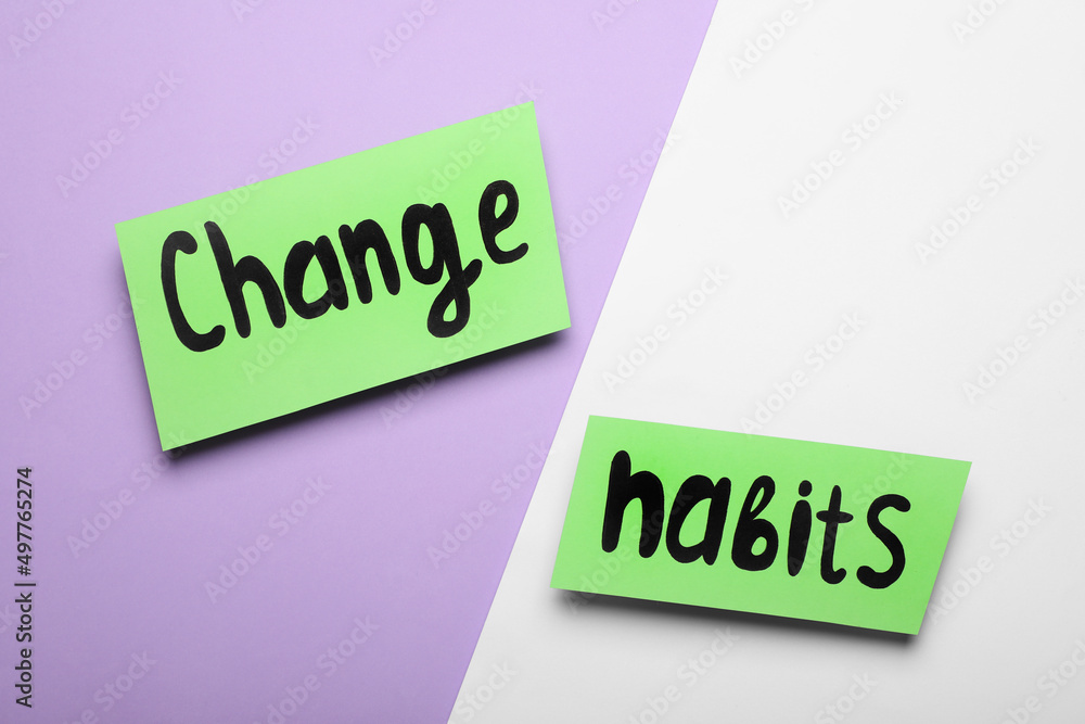 Paper notes with phrase Change Habits on color background, flat lay Paper notes with phrase Change Habits on color background, flat lay