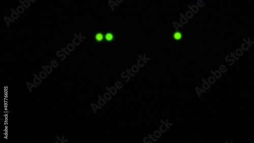 Wi-Fi router or modem light blinking. Wireless internet connection. Flashing green warning lights in black darkness. The process of transferring information through modern means of communication. photo