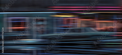 Motion blur abstract image of a car speeding through a town at night